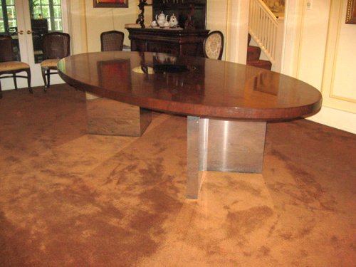 Dunbar Dining or Conference Table Mid to late 70s Designed by Roger Lee Sprunger, a protege of Edward Wormley An iconic piece wth high mirrored pristine finish of Brazilian Rosewood with Mahogany banned edges.  Polished Chrome Planks â€“ Plinths V shaped bases and middle secret drawer with Brass Dunbar tag.  Oval in shape and measuring 110 in. x 60 in.     - Extraordinary Auction - Nike Spillson Home Interiors & Furnishings